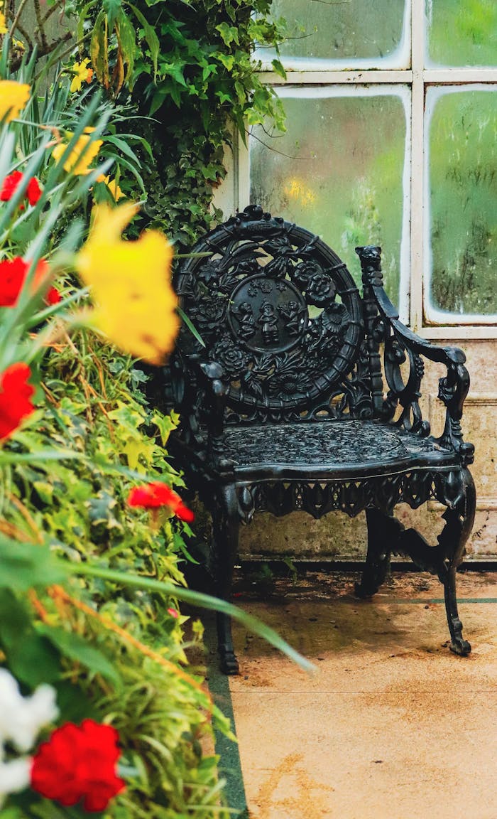The Art of Drawing Readers In: Your attractive post title goes here Decorative cast iron chair surrounded by colorful flowers in a lush garden setting.
